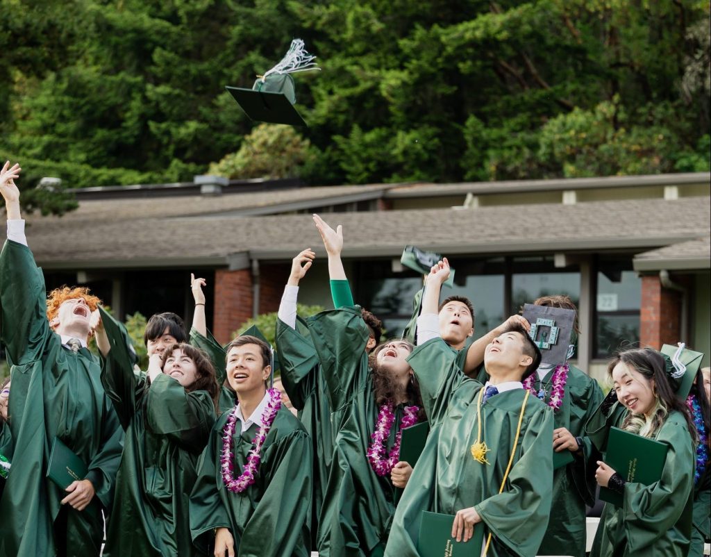 Graduating seniors throw their caps in the air to celebrate the end of their time as students at Charles Wright Academy during commencement.