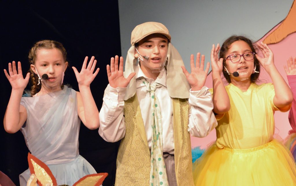 Three Lower School students pose while singing during a performance of Seussical Jr.