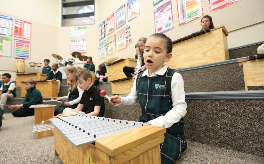 Lower School students play the xylophone in music class.